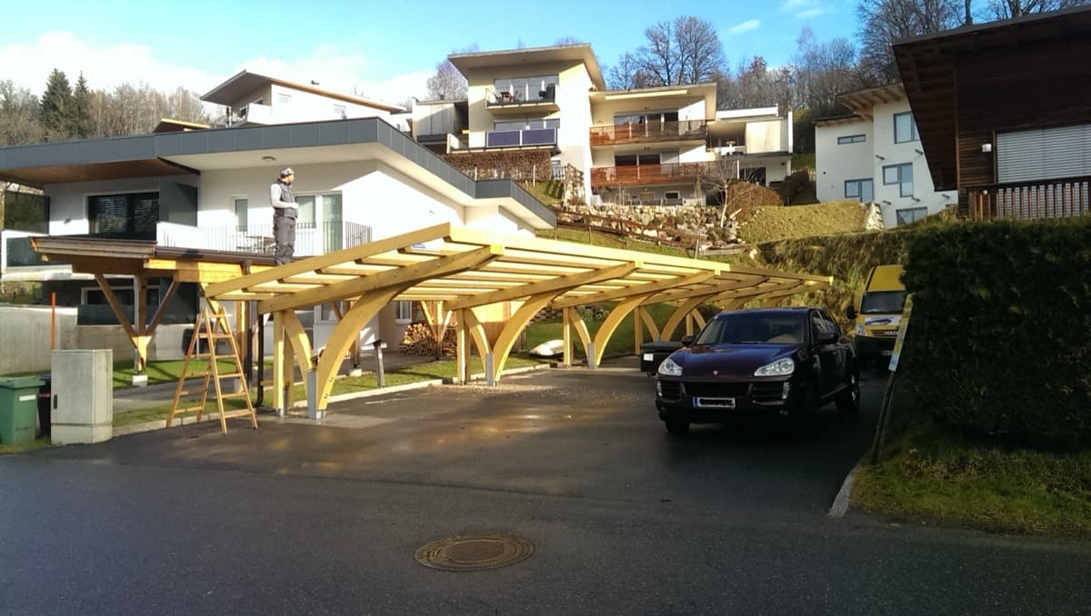 Carport-Rohbau mit Bogenstützen in Wohnsiedlung